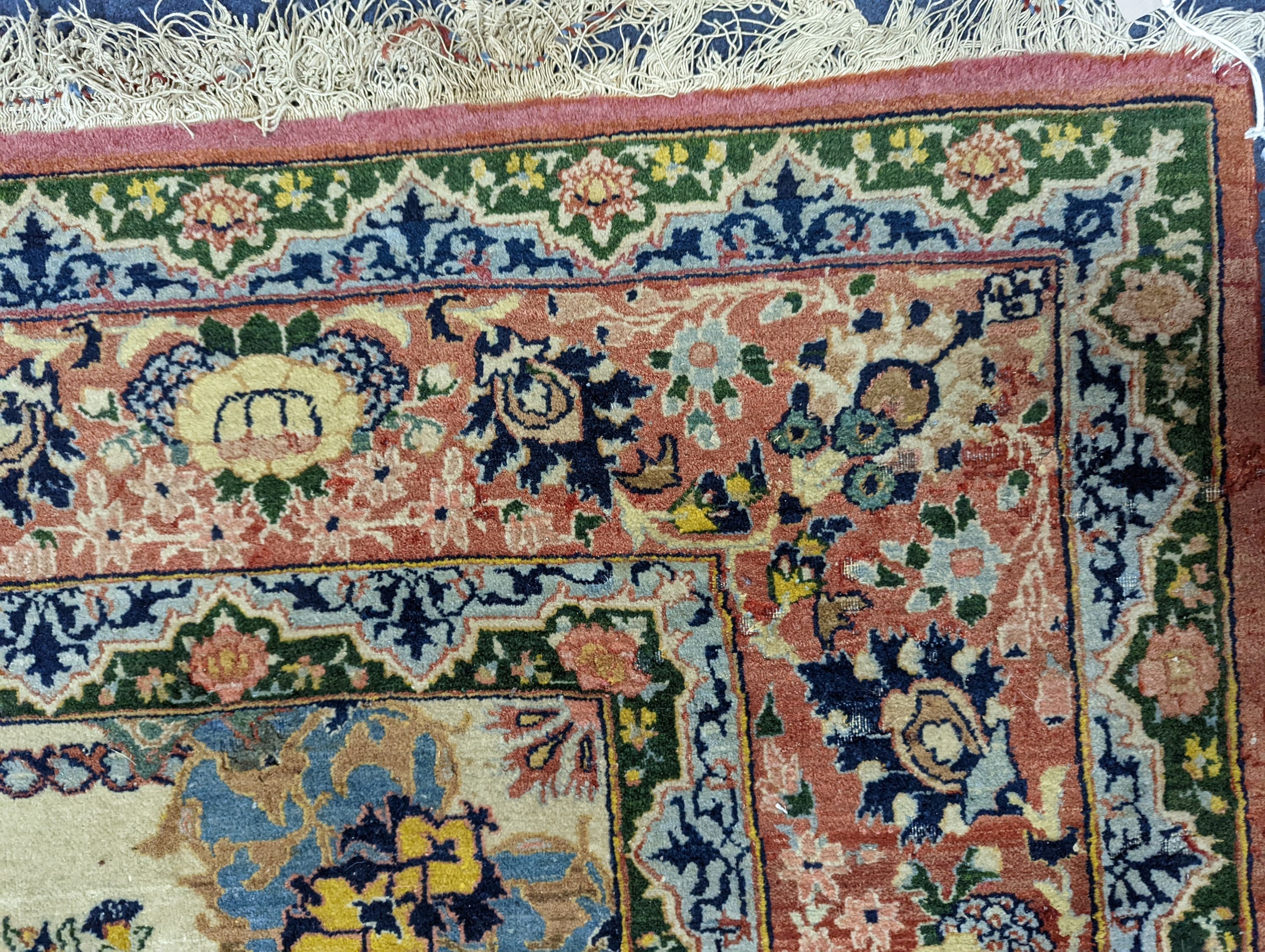 A part silk Isfahan cream rug with central floral scroll medallion, 196 x 140cm